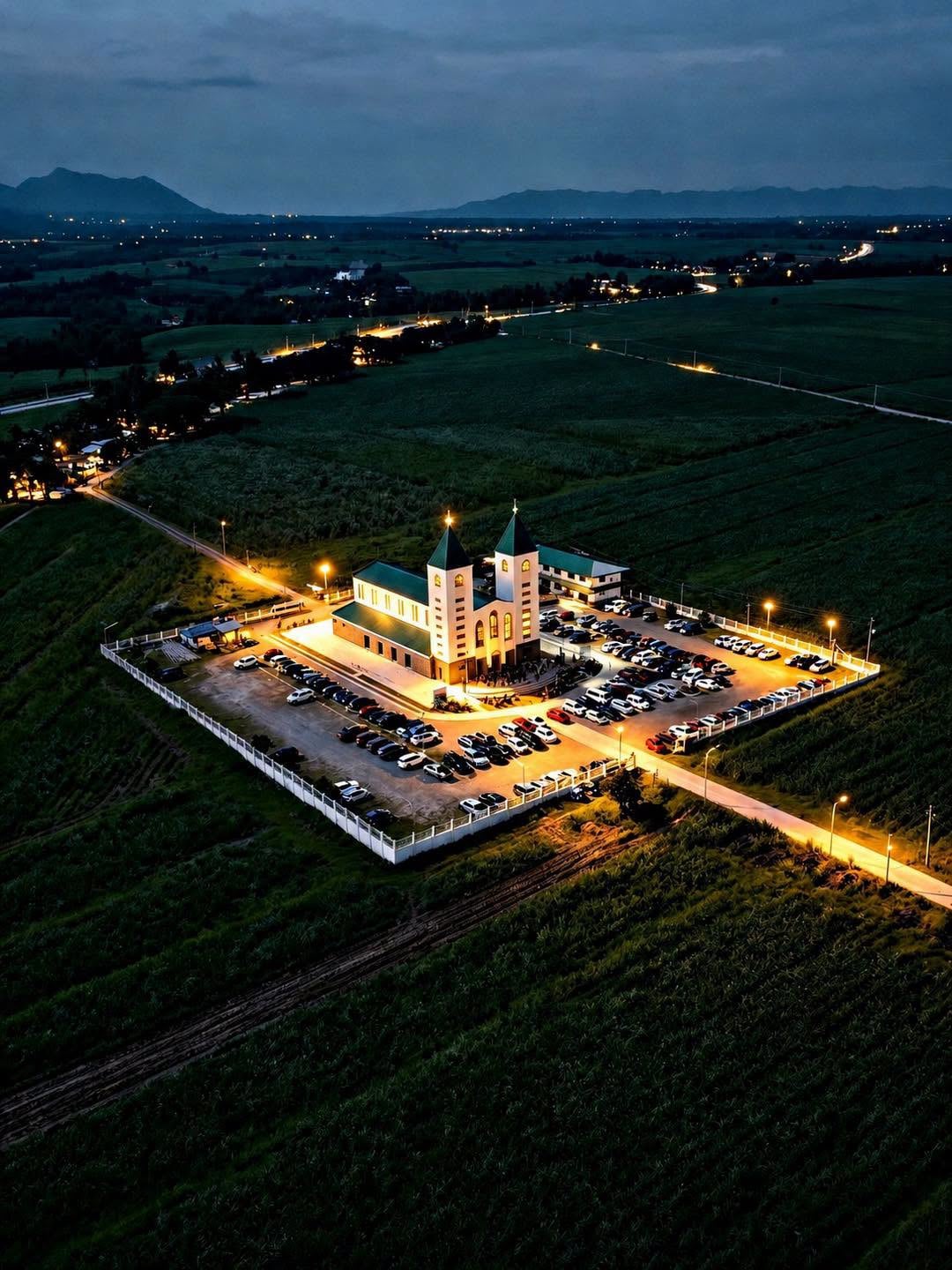 St. James the Greater Church illuminated at dusk, viewed from above
